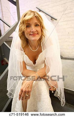 Bride sitting in stairwell stairs View Large Photo Image Stock Photograph - Bride sitting in stairwell stairs. Fotosearch