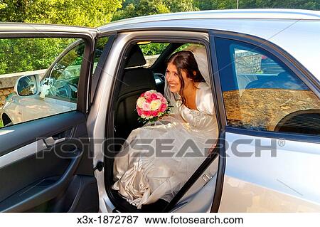 Bride stepping out of the wedding car View Large Photo Image Stock Photo - Bride stepping out of the wedding car. Fotosearch
