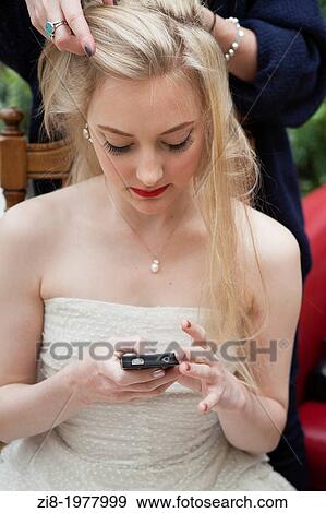 Bride texting, during make-up. View Large Photo Image Stock Photo - Bride texting, during make-up.. Fotosearch