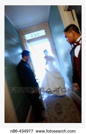 Stock Photo - Bride walking out front door. Fotosearch