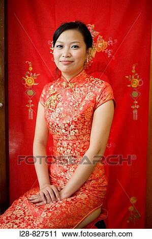 Bride wearing traditional Chinese clothing, smiling at camera, portrait View Large Photo Image Stock Image - Bride wearing traditional Chinese clothing, smiling at camera, portrait. Fotosearch