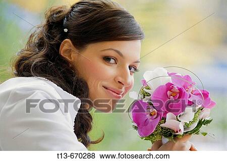 Bride with flowers is happy View Large Photo Image Stock Photo - Bride with flowers is happy. Fotosearch