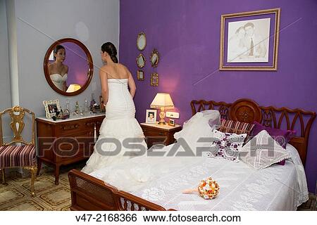 Bride with the finishing touches of makeup in their room View Large Photo Image Stock Photograph - Bride with the finishing touches of makeup in their room. Fotosearch