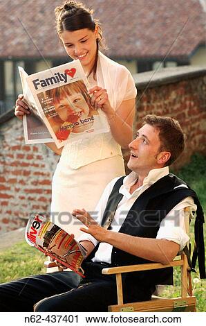 Stock Image - Bridegrooms reading newspapers.. Fotosearch