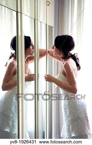 Stock Image - Bride's image reflected in mirror. Fotosearch