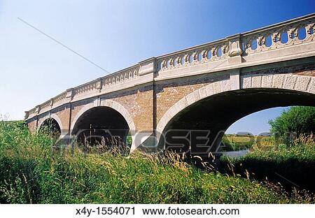 Stock Image - Bridge, constructed during baroque - art noveau period, over the river Cierna voda in Kralova pri Senci, Slovakia. Fotosearch