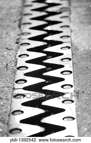 Stock Image - Bridge Fingers, Metal Teeth Construction Between Road and Bridge Expansion Joint. Fotosearch