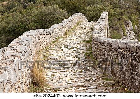 Stock Image - Bridge over Llierca River - 14th Century -, between Sadernes and Montagut villages, La Garrotxa, Girona, Spain.. Fotosearch