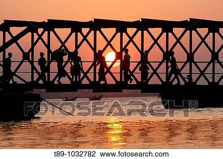 Stock Image - bridge over river at sunset in Yangon, Myanmar. Fotosearch