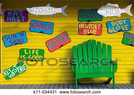 Stock Image - Bright yellow shop signs on the Florida Keys, USA. Fotosearch