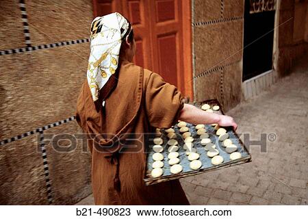 Bringing pastry to the oven, with a? Herm's foulard? on the head, in the Medina of Tanger. Morocco. View Large Photo Image Stock Image - Bringing pastry to the oven, with a? Herm's foulard? on the head, in the Medina of Tanger. Morocco.. Fotosearch