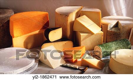 British cheese shop photo A selection of Cheeses, From left, Red Leicester cheese on top of Leicester cheese, in the black wax, Dutch cheese, then a truckle of farmhouse mature cheddar cheese then a stilton cheese with a French Roule in front View Large Photo Image Stock Image - British cheese shop photo A selection of Cheeses, From left, Red Leicester cheese on top of Leicester cheese, in the black wax, Dutch cheese, then a truckle of farmhouse mature cheddar cheese then a stilton cheese with a French Roule in front. Fotosearch