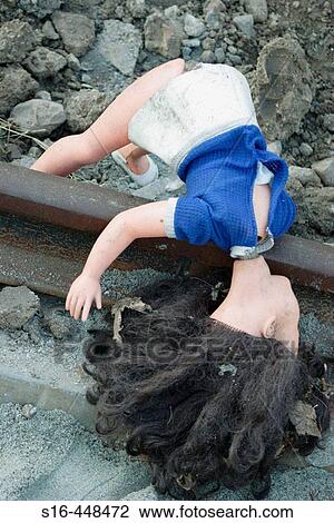 Broken doll thrown on a rail track View Large Photo Image Stock Image - Broken doll thrown on a rail track. Fotosearch