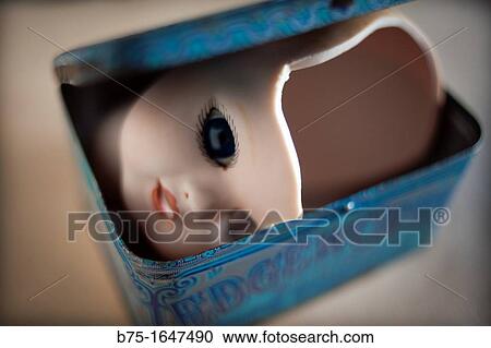 Stock Image - Broken doll??s head in a box. Fotosearch