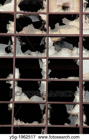 Stock Photo - broken windows at derelict property in rome italy.. Fotosearch