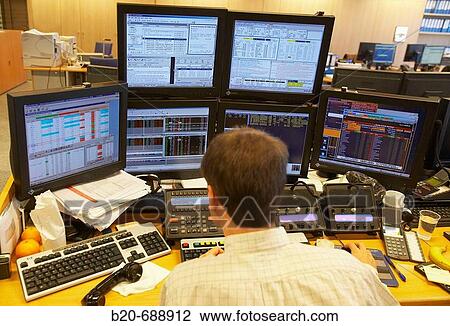 Stock Image - Broker, stock exchange data monitors. Fotosearch