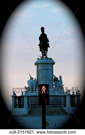 Stock Image - Bronze statue of Dom Jose 1 and red man stop sign on pedestrian crossing, Praca do Comercio, Lisbon, Portugal, Europe. Fotosearch