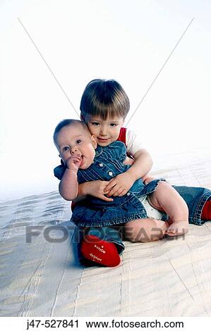 brother, age 3 and sister, age 1, sitting on the floor, in the studio, smiling and hugging View Large Photo Image Stock Image - brother, age 3 and sister, age 1, sitting on the floor, in the studio, smiling and hugging. Fotosearch