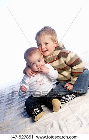 brother, age 3 and sister, age 1, sitting on the floor, hugging View Large Photo Image Stock Image - brother, age 3 and sister, age 1, sitting on the floor, hugging. Fotosearch
