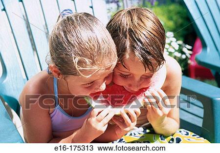Brother and sister eating watermelon View Large Photo Image Stock Image - Brother and sister eating watermelon. Fotosearch