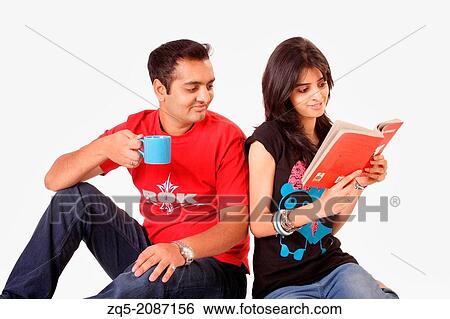 Brother and sister enjoying coffee and reading book, Pune, India. View Large Photo Image Stock Photograph - Brother and sister enjoying coffee and reading book, Pune, India.. Fotosearch