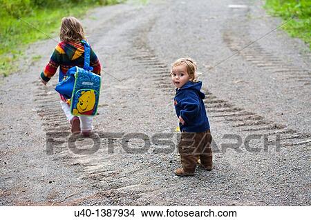 Brother and sister on dirt road View Large Photo Image Picture - Brother and sister on dirt road. Fotosearch