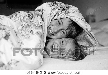 Brother and sister playing in bed View Large Photo Image Stock Image - Brother and sister playing in bed. Fotosearch