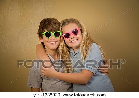 Brother and sister wearing heart-shaped sunglasses View Large Photo Image Stock Image - Brother and sister wearing heart-shaped sunglasses. Fotosearch