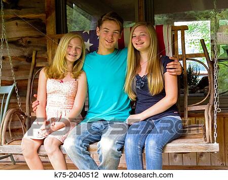 Brother hugging two sisters on porch swing View Large Photo Image Stock Image - Brother hugging two sisters on porch swing. Fotosearch