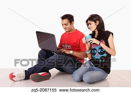 Brother sharing something on laptop computer with his sister, Pune, India. View Large Photo Image Stock Photography - Brother sharing something on laptop computer with his sister, Pune, India.. Fotosearch