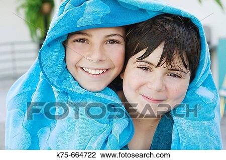 Brothers sharing beach towel. View Large Photo Image Stock Image - Brothers sharing beach towel.. Fotosearch