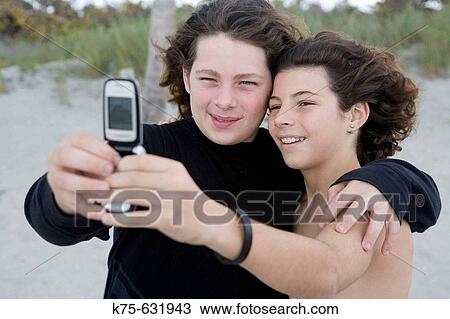 Brothers smiling for camera phone View Large Photo Image Stock Image - Brothers smiling for camera phone. Fotosearch