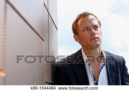 Brown haired young man looking thoughtful into the far distancel, Hamburg, Germany, Europe View Large Photo Image Picture - Brown haired young man looking thoughtful into the far distancel, Hamburg, Germany, Europe. Fotosearch