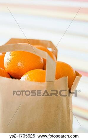 Stock Photograph - Brown paper bag full of oranges. Fotosearch