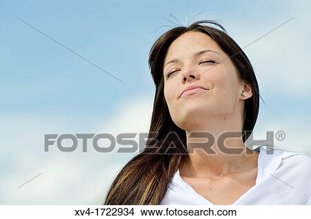 Picture - Brunette breathing fresh air in the ruralscape. Fotosearch