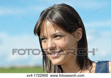 Stock Image - Brunette breathing fresh air in the ruralscape. Fotosearch