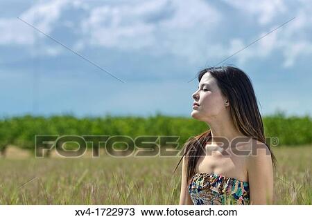 Brunette breathing fresh air in the ruralscape View Large Photo Image Stock Image - Brunette breathing fresh air in the ruralscape. Fotosearch