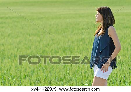 Brunette breathing fresh air in the ruralscape View Large Photo Image Stock Photo - Brunette breathing fresh air in the ruralscape. Fotosearch
