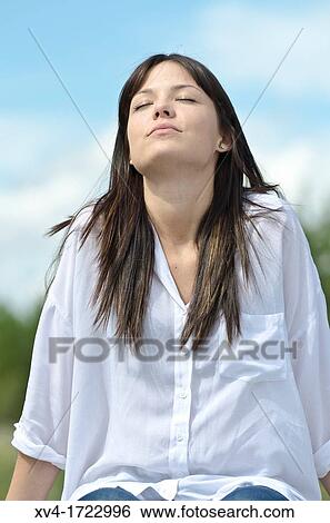 Brunette breathing fresh air in the ruralscape View Large Photo Image Stock Photograph - Brunette breathing fresh air in the ruralscape. Fotosearch