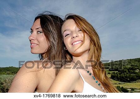 Brunette couple relaxing and enjoy in the countryside looking at camera View Large Photo Image Stock Photo - Brunette couple relaxing and enjoy in the countryside looking at camera. Fotosearch