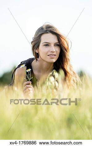 Stock Photograph - Brunette enjoy in the countryside. Fotosearch