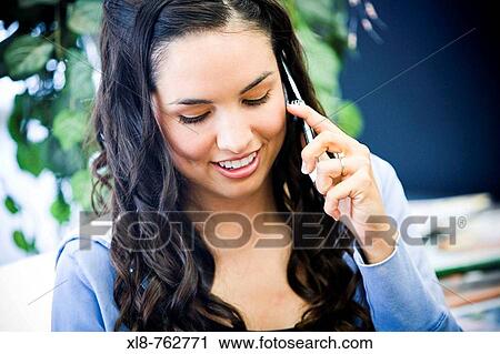 brunette girl smiling on the phone View Large Photo Image Stock Image - brunette girl smiling on the phone. Fotosearch