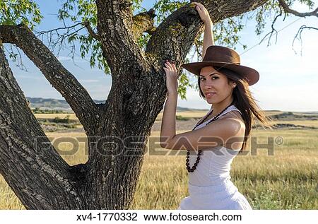 Brunette on the tree enjoy in the countryside View Large Photo Image Stock Image - Brunette on the tree enjoy in the countryside. Fotosearch