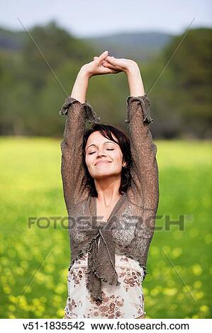 Brunette pretty woman breathing fresh air in countryside View Large Photo Image Stock Image - Brunette pretty woman breathing fresh air in countryside. Fotosearch