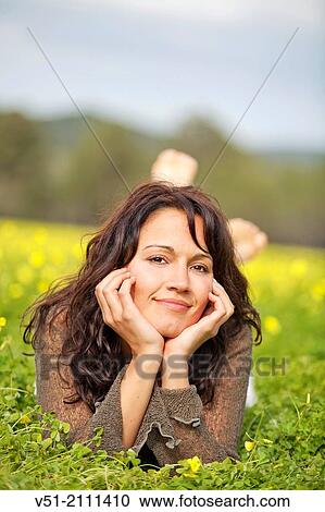 Brunette pretty woman in park smiling at camera View Large Photo Image Stock Image - Brunette pretty woman in park smiling at camera. Fotosearch