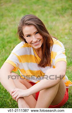 Brunette pretty woman in park smiling at camera View Large Photo Image Stock Photo - Brunette pretty woman in park smiling at camera. Fotosearch