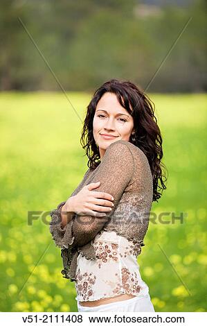Brunette pretty woman in park smiling at camera View Large Photo Image Stock Photo - Brunette pretty woman in park smiling at camera. Fotosearch