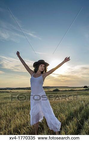 Brunette relaxing in the countryside with arms raised View Large Photo Image Stock Photography - Brunette relaxing in the countryside with arms raised. Fotosearch