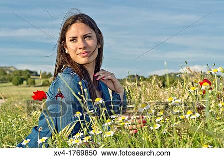 Brunette relaxing with poppy and enjoy in the countryside View Large Photo Image Stock Image - Brunette relaxing with poppy and enjoy in the countryside. Fotosearch