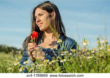 Brunette relaxing with poppy and enjoy in the countryside View Large Photo Image Stock Photo - Brunette relaxing with poppy and enjoy in the countryside. Fotosearch